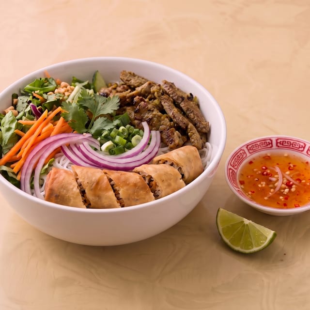 Grilled Lemongrass Sliced Beef and Egg Roll Vermicelli Bowl.